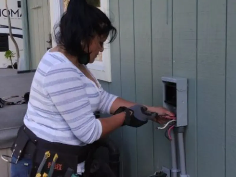 Licensed electrician wiring an exterior subpanel in Bolivar